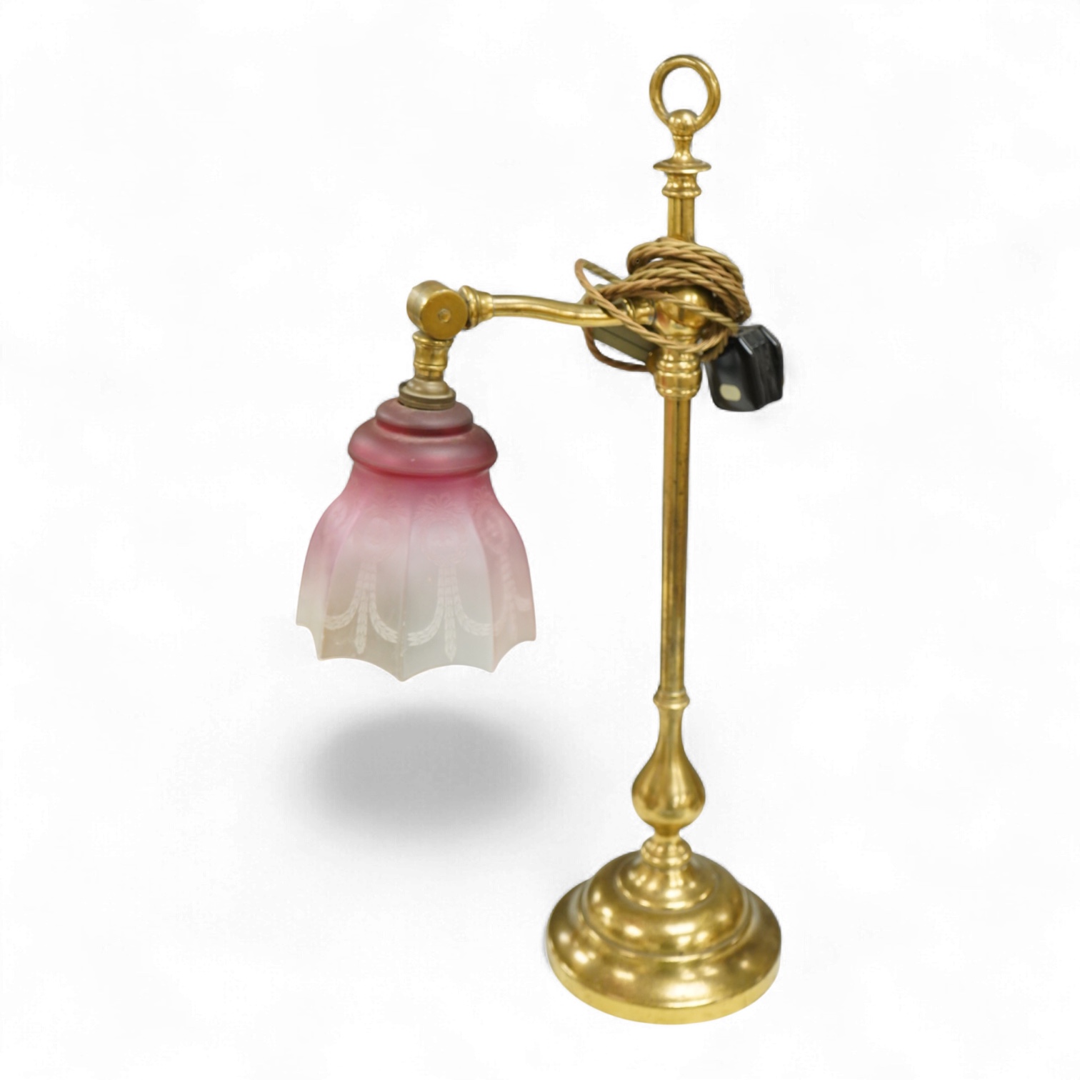 A late Victorian brass desk light with cranberry shade, 59cm